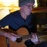 Steve Bassett plays his acoustic guitar at rehearsals.