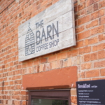 A window and menu at The Barn Coffee Shop.