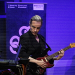 Rich Wilson playing guitar, with Martin Trotman's keyboard in view.